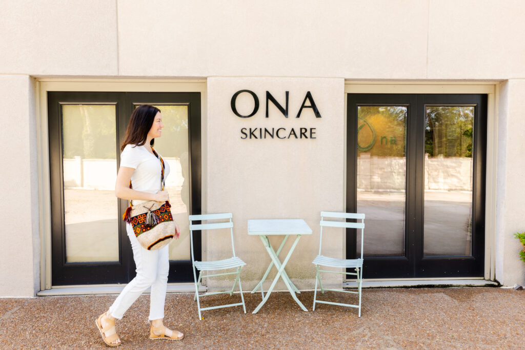 Exterior of the Ona Skincare building with a patient wearing white passing by